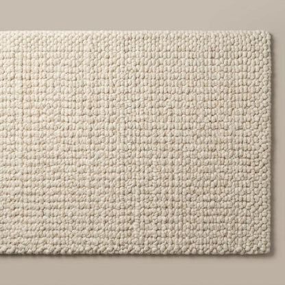 Neutral ivory wool area rug with textured surface for modern organic home interiors