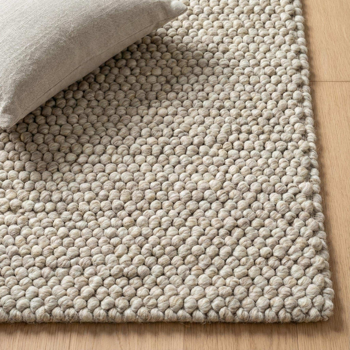 Handwoven chunky wool pebble rug in neutral beige with textured pebble weave for Scandinavian minimalist decor