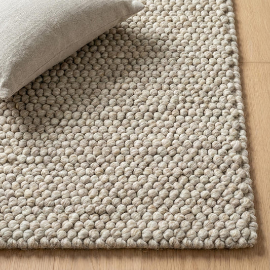 Handwoven chunky wool pebble rug in neutral beige with textured pebble weave for Scandinavian minimalist decor