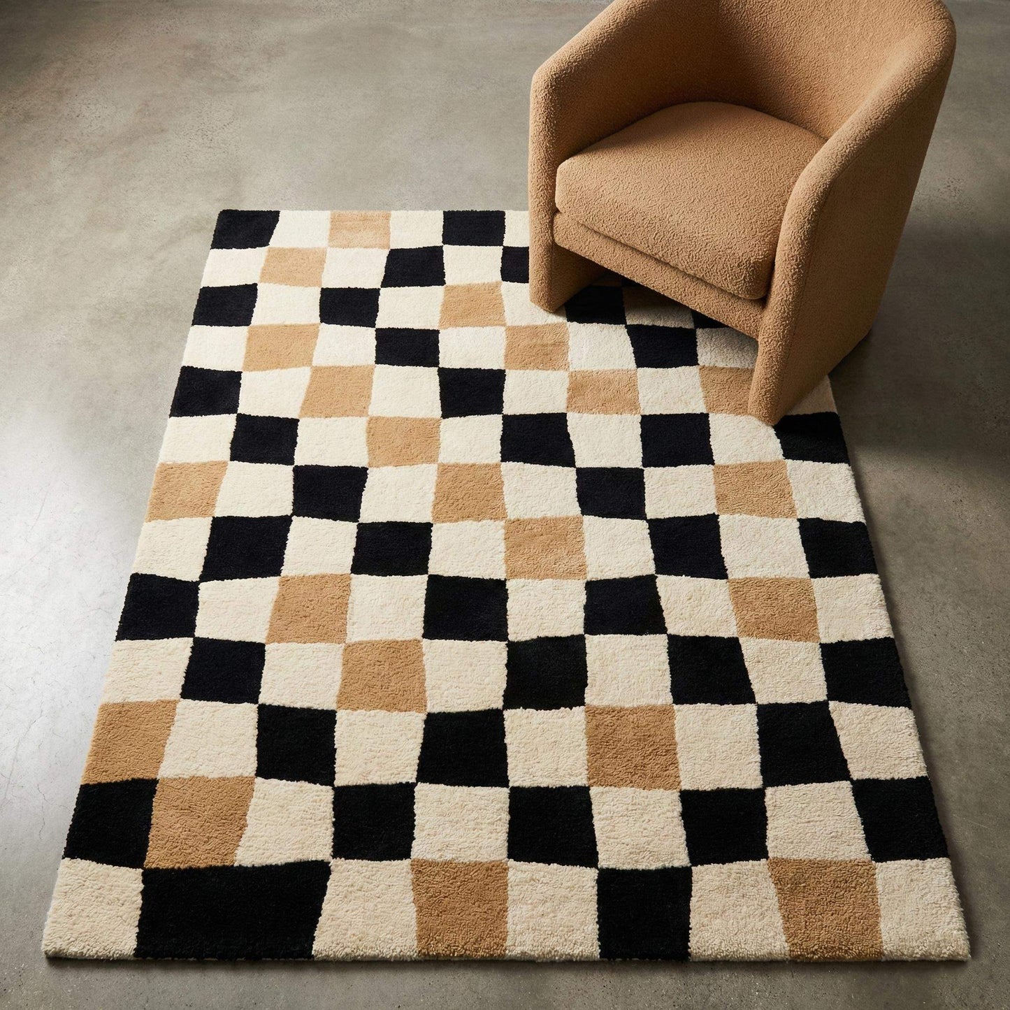 Modern geometric checkerboard area rug in cream, tan and black, styled with accent chair in minimalist interior __etsy:7640779561