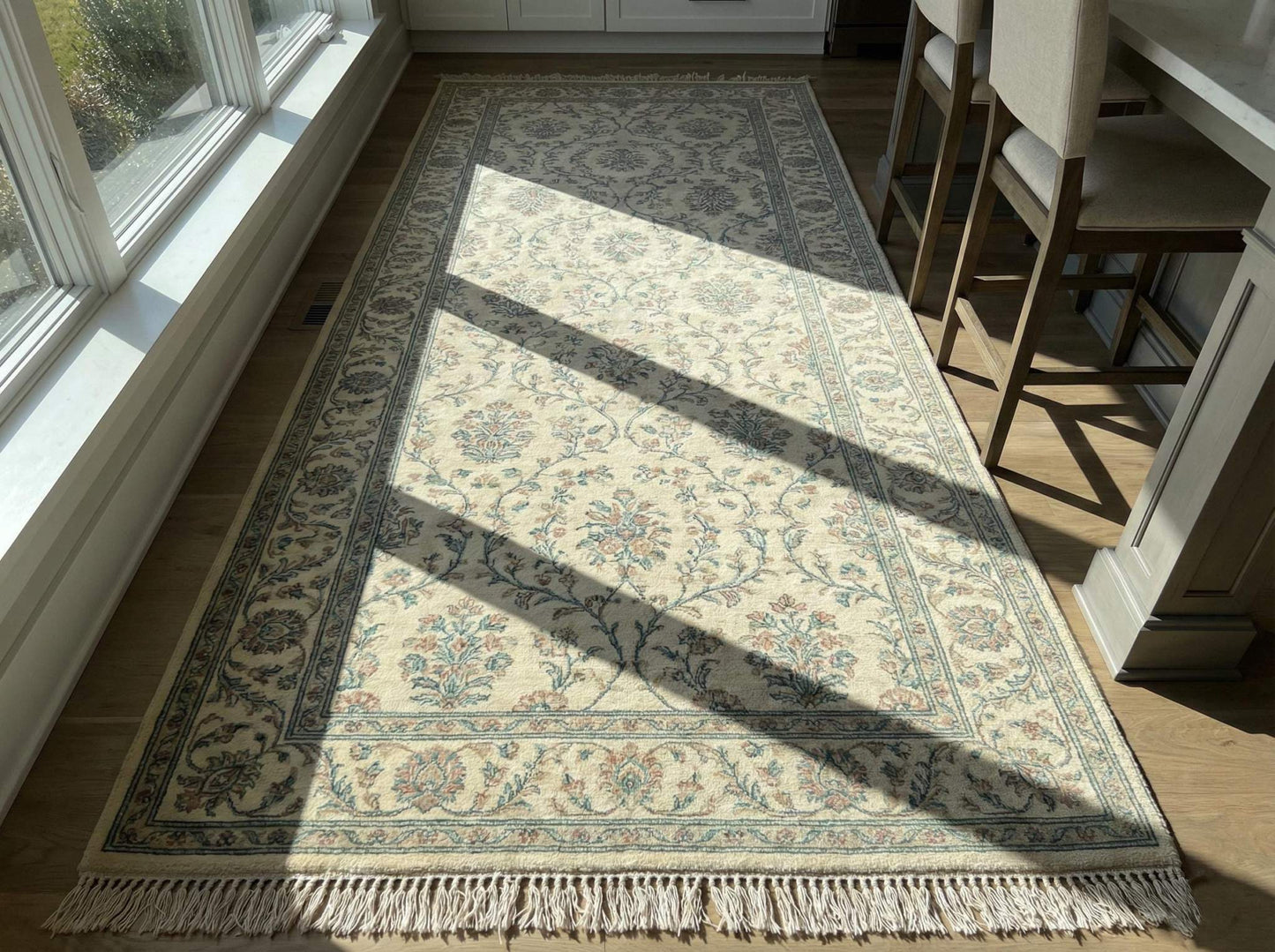 Ivory blue floral hand knotted wool area rug with traditional Persian-inspired design and soft ivory base