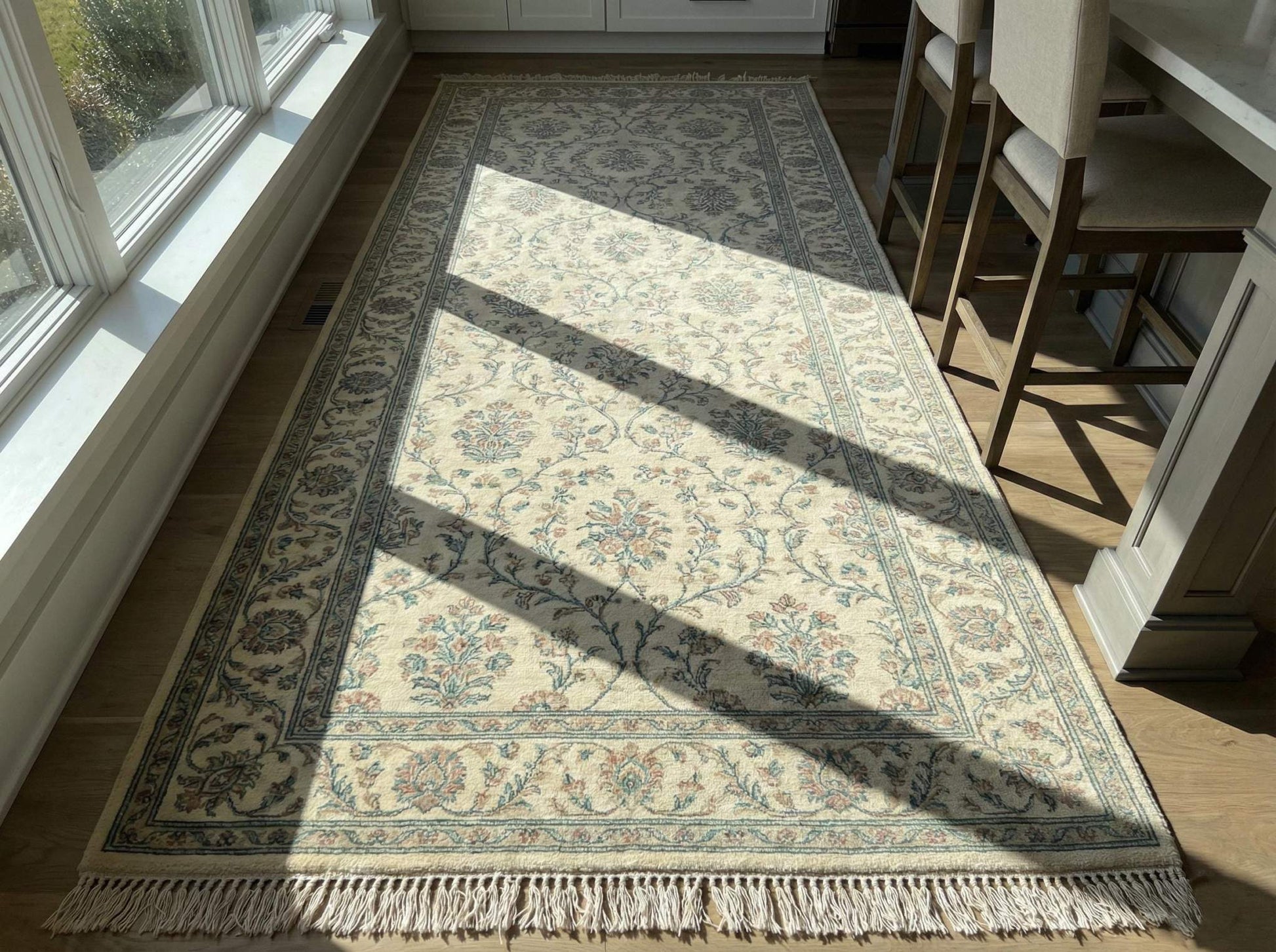 Ivory blue floral hand knotted wool area rug with traditional Persian-inspired design and soft ivory base