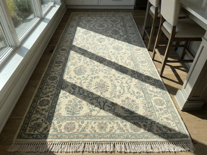 Ivory blue floral hand knotted wool area rug with traditional Persian-inspired design and soft ivory base