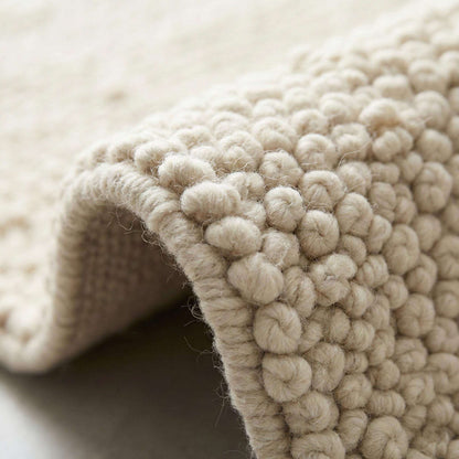 Ivory chunky wool area rug with thick looped texture for cozy modern minimalist interiors
