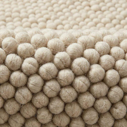 Ivory chunky wool rug with thick looped texture for cozy modern minimalist interiors