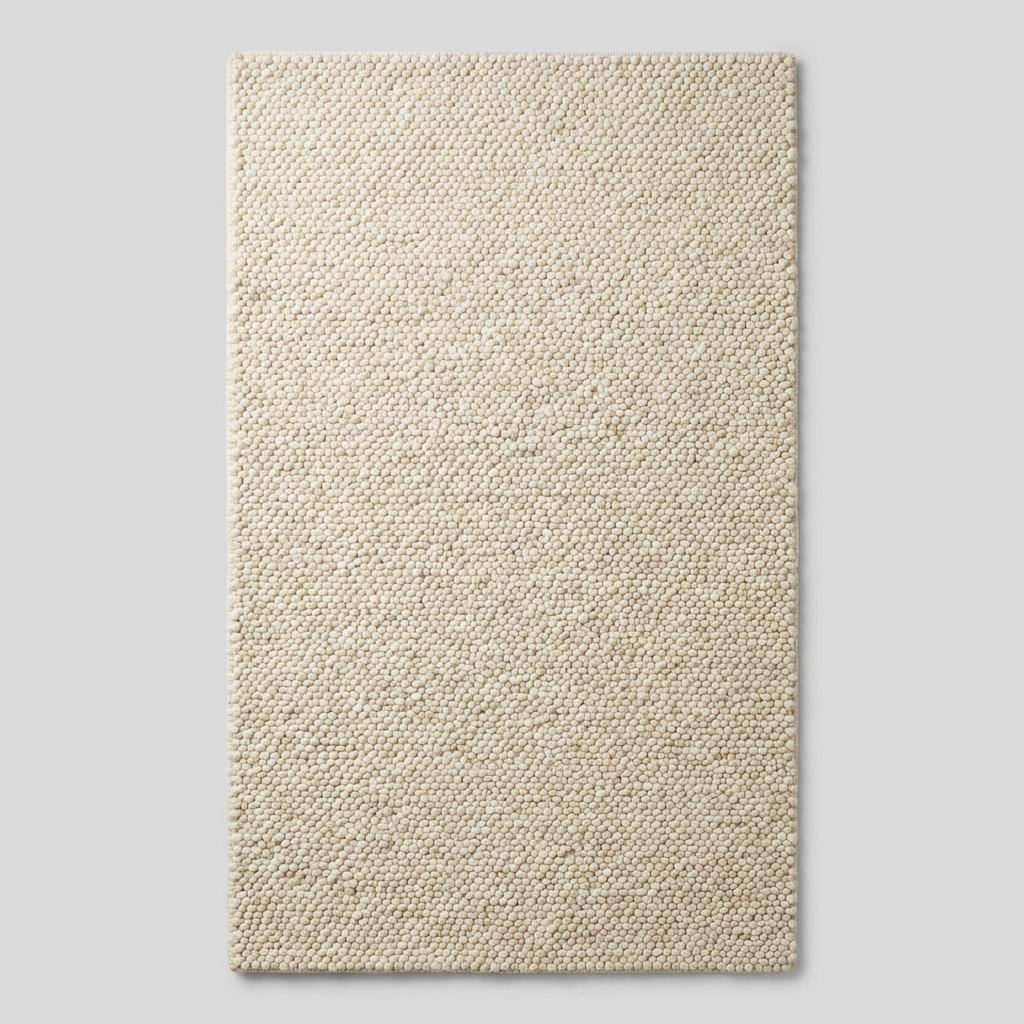 Ivory chunky wool area rug with thick looped texture for cozy modern minimalist interiors