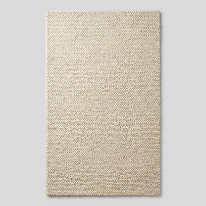 Ivory chunky wool area rug with thick looped texture for cozy modern minimalist interiors