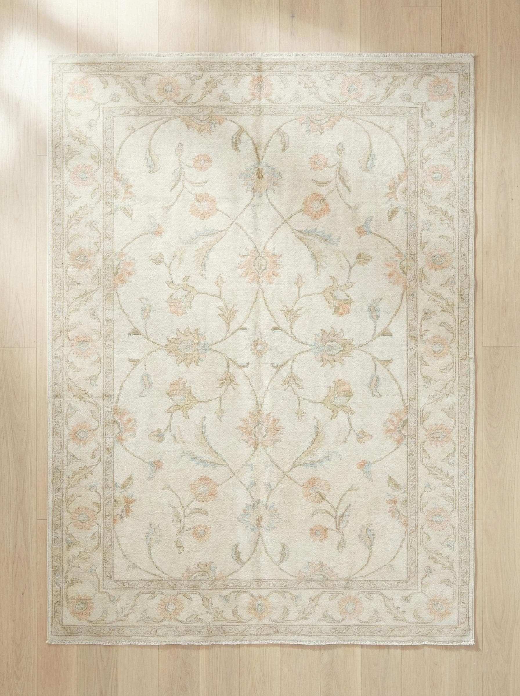 Ivory floral wool rug with delicate pastel flowers and soft low-profile pile for elegant living room decor
