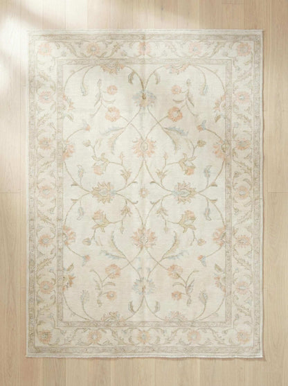Ivory floral wool rug with delicate pastel flowers and soft low-profile pile for elegant living room decor