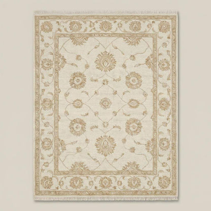 Neutral beige and ivory hand knotted floral rug with classic Oushak border design