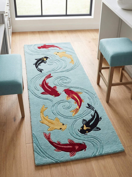 Handmade koi fish tufted rug runner with colorful red, gold, and black koi swimming on a soft aqua blue background in modern hallway interior. __etsy:7838047709