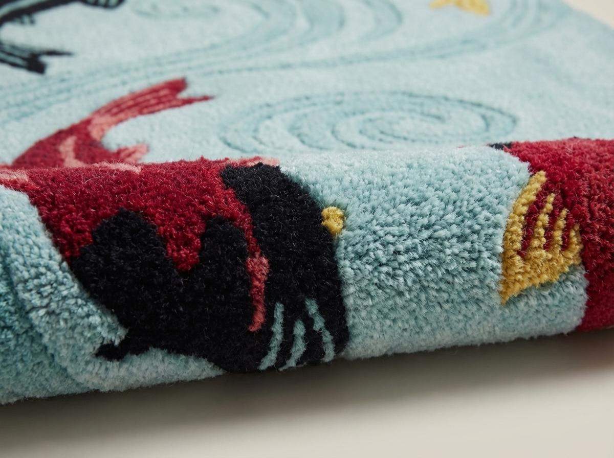 Close-up of hand-tufted wool rug texture showing raised pile, carved water swirl pattern, and detailed koi fish design. __etsy:7790118634