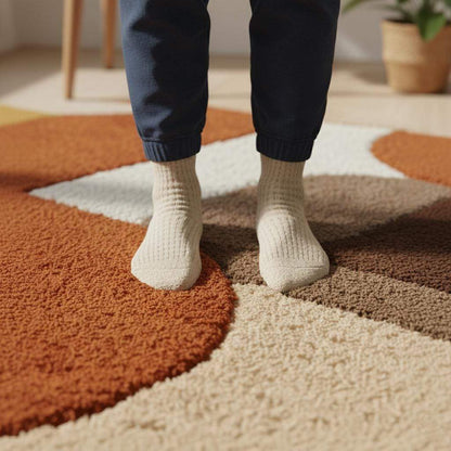 Mid century area rug with plush thick pile and geometric retro pattern in warm burnt orange, mustard yellow, and cream tones
