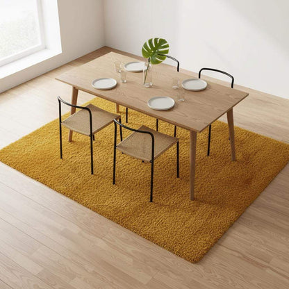 Mustard yellow area rug with retro mid-century design and low pile texture for living room decor