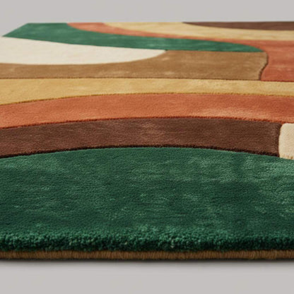 Close-up of hand-tufted rug showing dense plush cut-pile texture, soft fibers, clean carved edges, and smooth color transitions in a retro abstract pattern.
