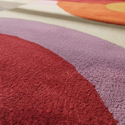 Mid-Century Modern Sunset Rug with abstract geometric circles in red, orange, yellow, and purple hues on living room floor