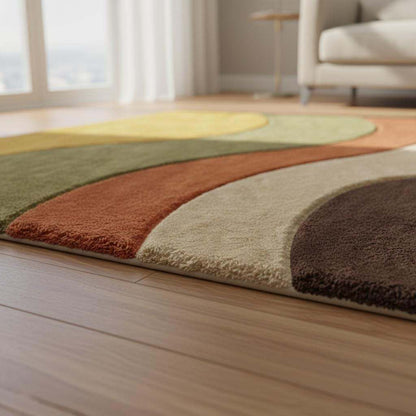 Warm earth tone modern area rug with curved color blocks, mid century style carpet for living room decor, shown from above on a parquet floor with natural light.