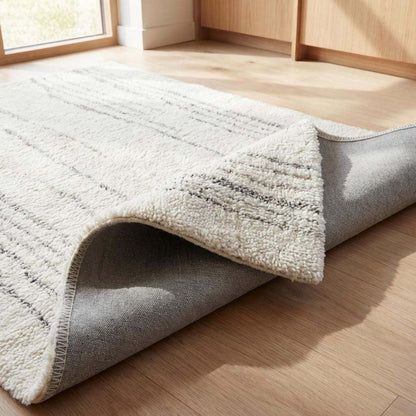 Minimalist cream runner rug hand tufted wool with subtle gray accents in modern kitchen hallway decor