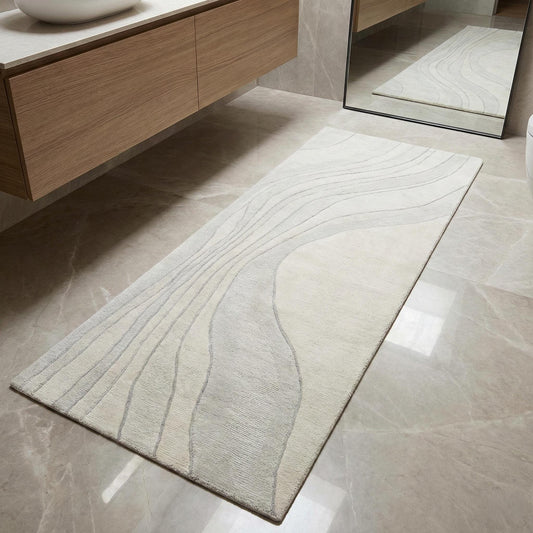 Minimalist neutral runner rug with soft wave pattern in ivory and beige tones, styled in a modern interior with clean lines.