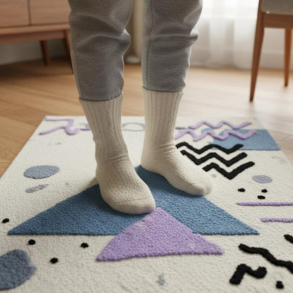Abstract geometric rug with pastel blue and lavender shapes on ivory bouclé texture