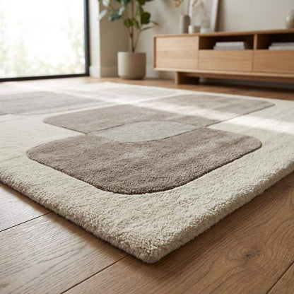 Detailed view of rug edge and carved border showing clean finishing, thick pile height, and dimensional texture of modern neutral geometric carpet.