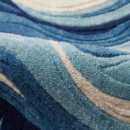 Hand-tufted modern abstract blue wave wool rug with sculpted texture for living room decor