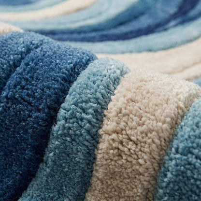 Close-up of hand-tufted wool rug showing carved wave texture with high-low pile in blue, teal, and ivory tones __etsy:7925015648