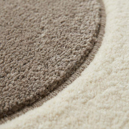 Modern pebble pattern tufted wool area rug with abstract carved design in neutral tones for living room