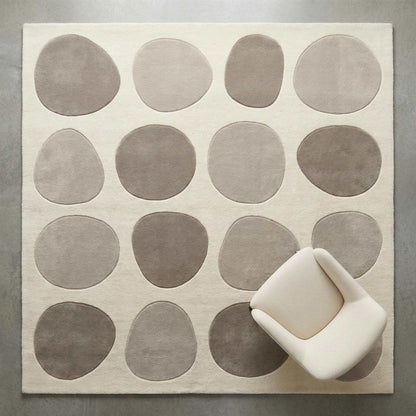 Modern pebble pattern tufted wool area rug with neutral tones in minimalist living room
