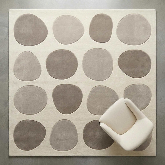 Modern pebble pattern tufted wool area rug with neutral tones in minimalist living room