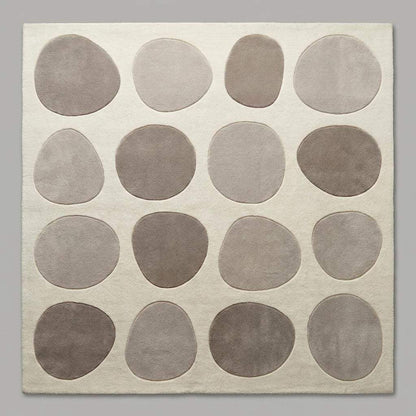 Modern pebble pattern tufted wool area rug with neutral tones in living room setting