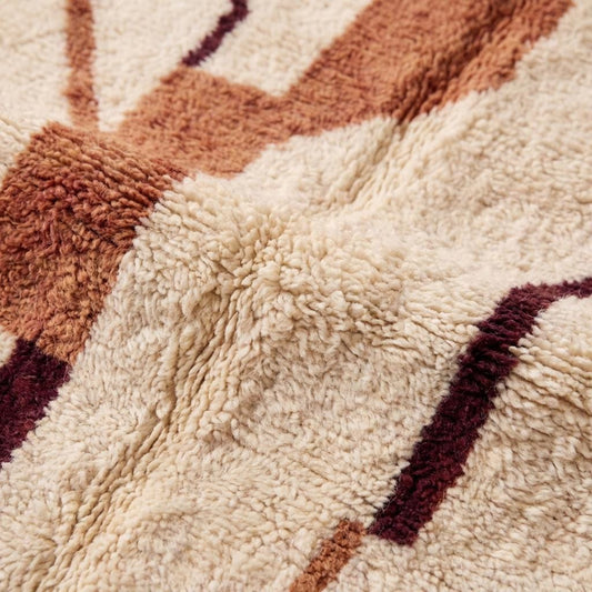 Close up view of thick pile texture and rust colored pattern detail