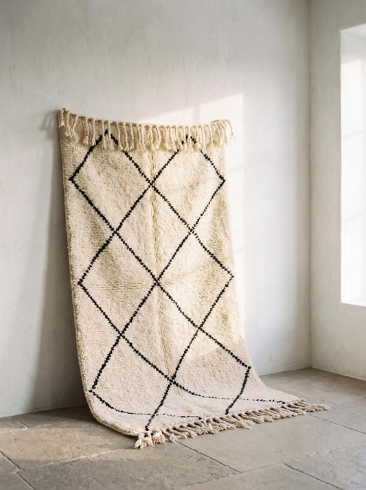 Moroccan diamond pattern ivory rug with black geometric lines and fringe