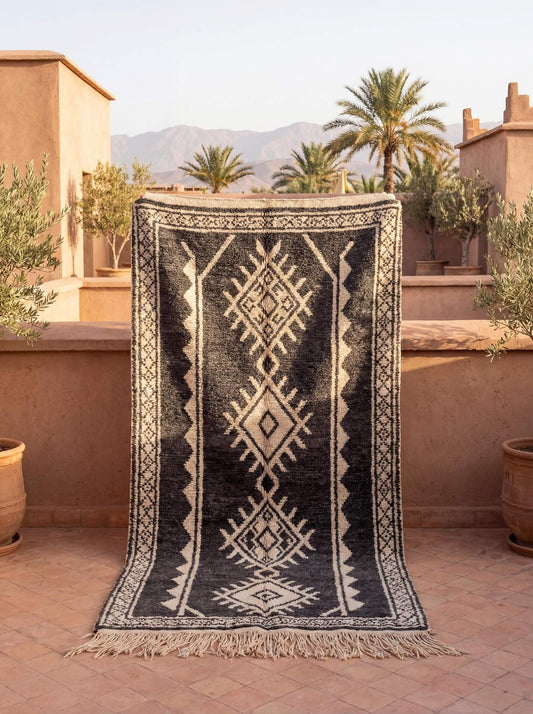Moroccan style charcoal and ivory geometric rug with stacked diamond tribal pattern