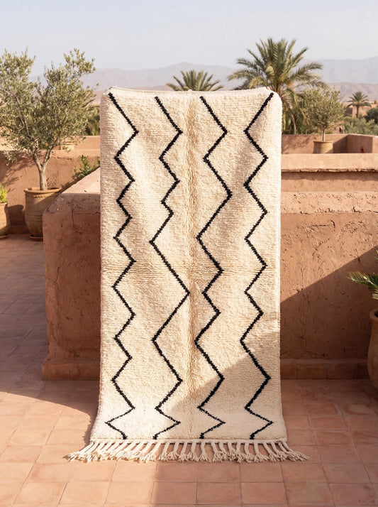 Moroccan geometric rug with ivory base and black Berber zigzag tribal pattern