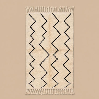Neutral geometric Berber style rug with fringe tassels