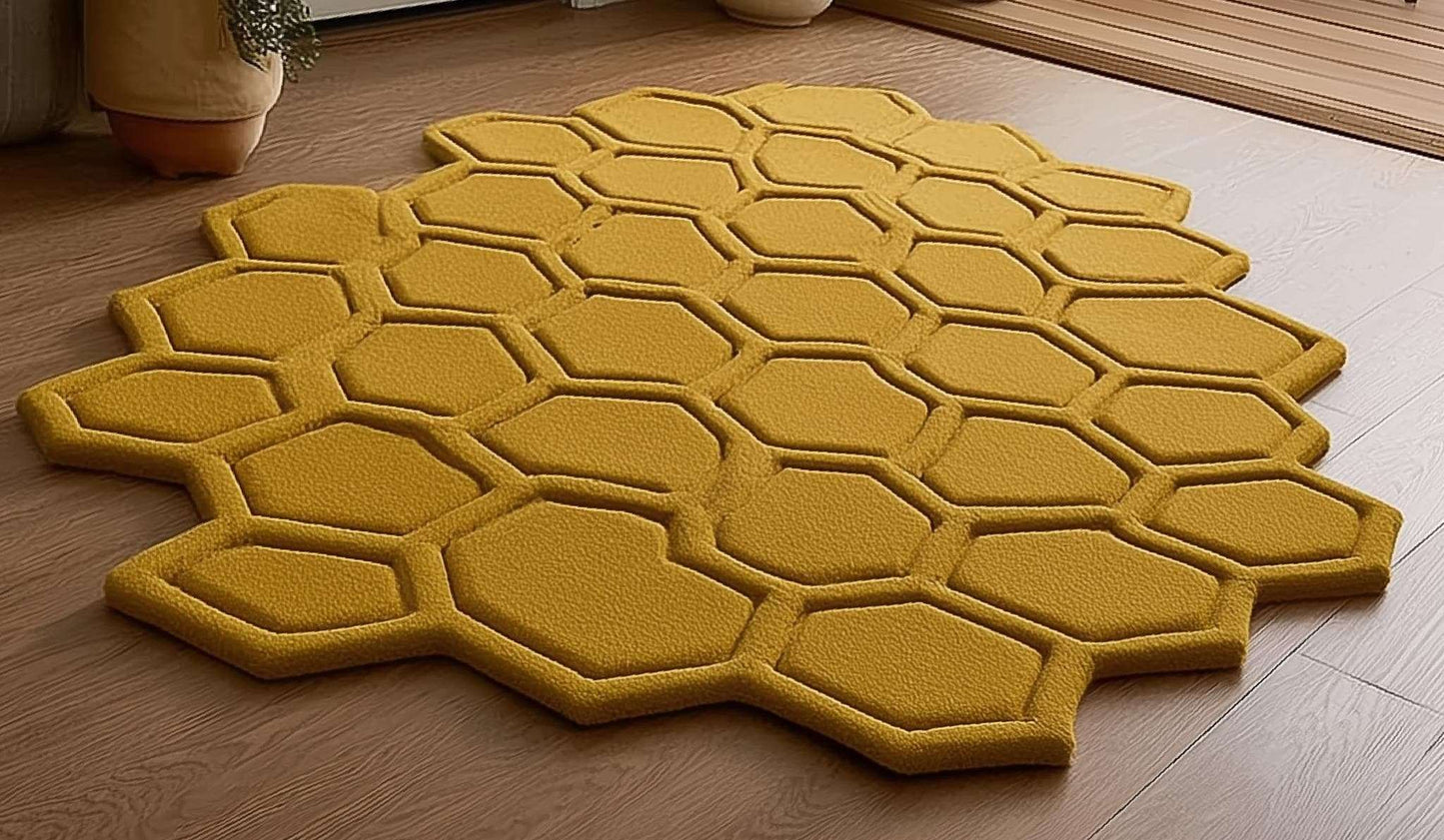 Mustard honeycomb sculpted hexagon rug with raised texture on wood floor by entryway