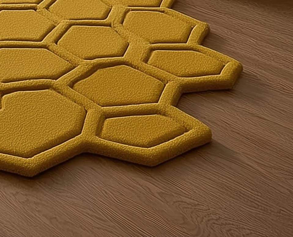 Mustard honeycomb rug with sculpted hexagon pattern on wood floor near entryway with plants