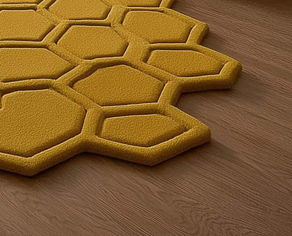 Mustard honeycomb rug with sculpted hexagon pattern on wood floor near entryway with plants