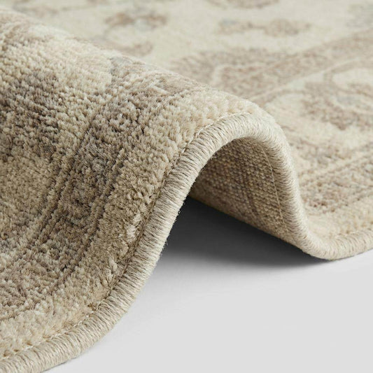 Close-up of hand knotted wool rug showing dense pile texture, individual knots, and natural fiber variation