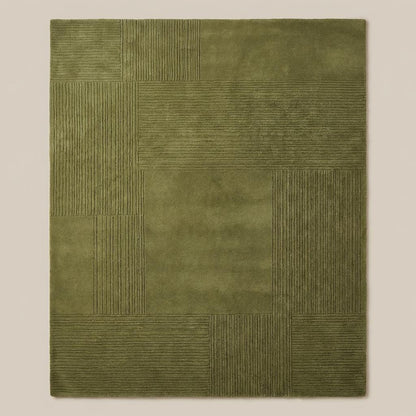 Top down view of olive green geometric patchwork rug displaying full square panel layout and textured detailing