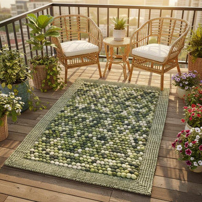 Close-up of felted wool ball rug handmade – olive green balls with cream accents, plush texture.