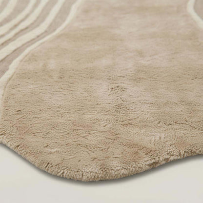 Hand-tufted organic wavy rug in beige with irregular shape and soft plush texture for modern minimalist decor