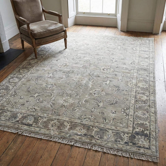Hand-knotted Oushak floral wool rug with neutral vintage tones and classic border design
