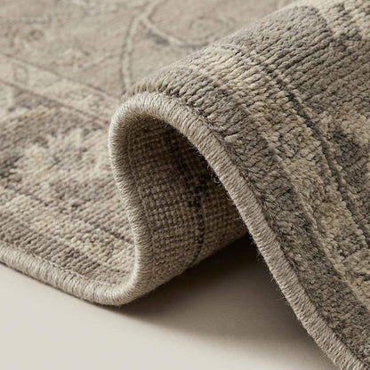 Close-up of hand knotted wool pile showing fine knots, soft low pile texture and woven cotton foundation