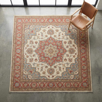 Hand-knotted Oushak floral medallion wool rug in soft ivory tones with traditional craftsmanship and timeless design