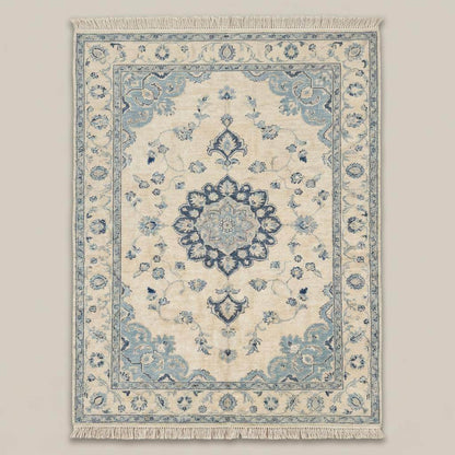 Blue ivory Oushak area rug with detailed border and floral motifs on wooden floor near window __etsy:7872266063