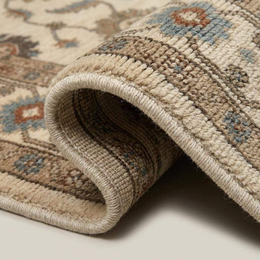 Close-up view of hand knotted wool fibers showing low pile texture, detailed floral motifs, artisan craftsmanship, and durable construction. __etsy:8074603256