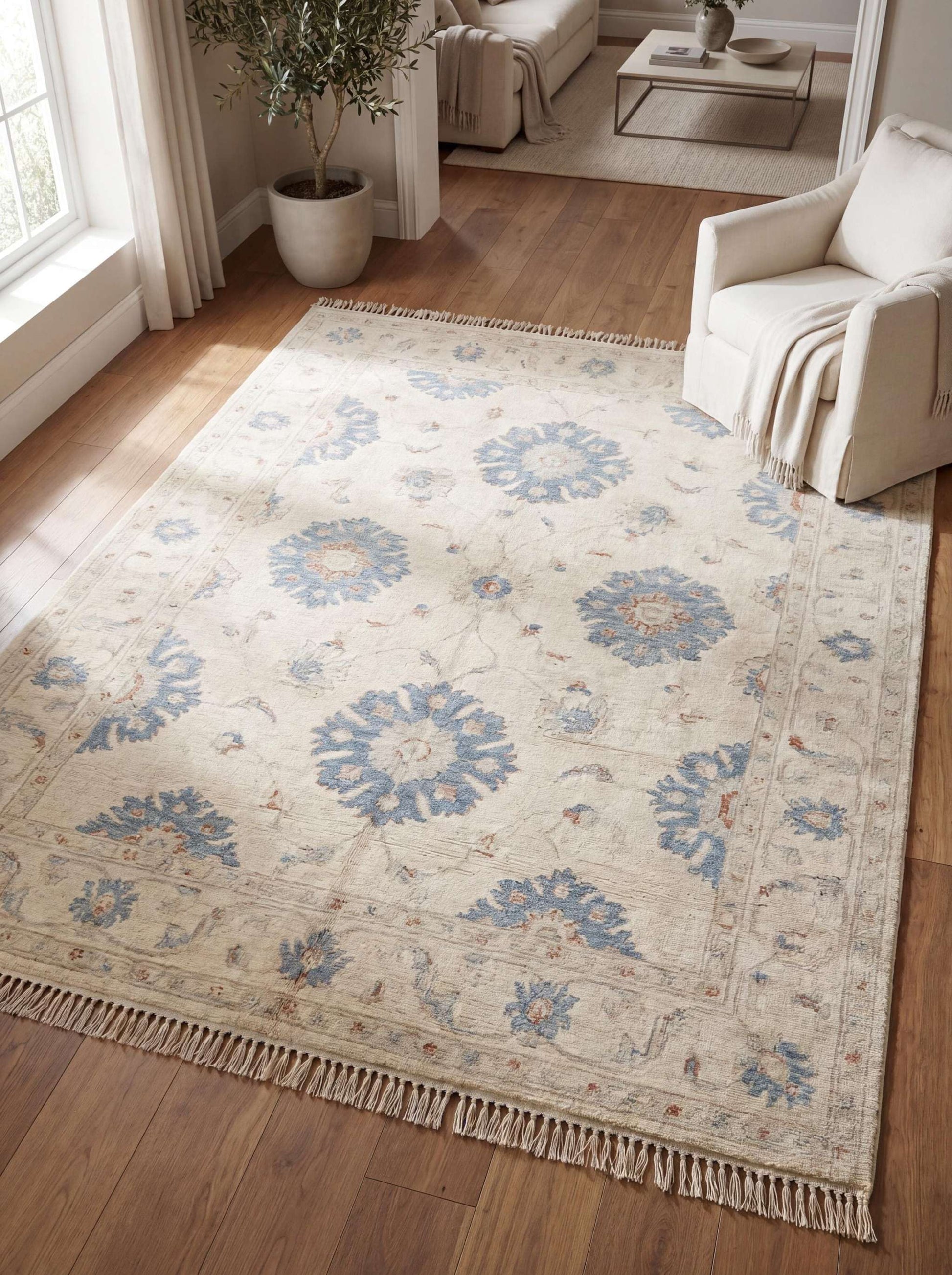 Hand knotted Oushak rug in ivory with blue floral motifs styled in modern living room on wood flooring __etsy:8005562683