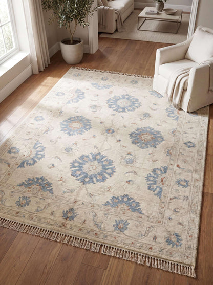 Hand knotted Oushak rug in ivory with blue floral motifs styled in modern living room on wood flooring __etsy:8005562683